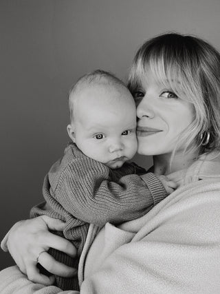 Founder and her baby Darcy in black and white