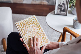 Person holding a book titled 'Grandma's Story' with a blurred background