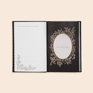 Open book with decorative cover and page on a beige background