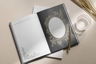Open notebook with decorative cover and pen on a light surface