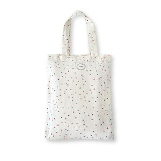 White tote bag with red polka dots on a white background