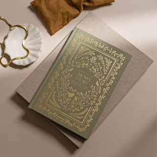 Decorative book with ornate cover on a beige surface