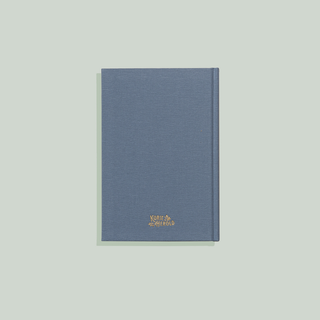 Blue notebook with a gold logo on a light gray background