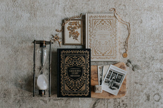 Decorative items including a book titled 'Grandpa's Story', an hourglass, and vintage photos on a textured surface.